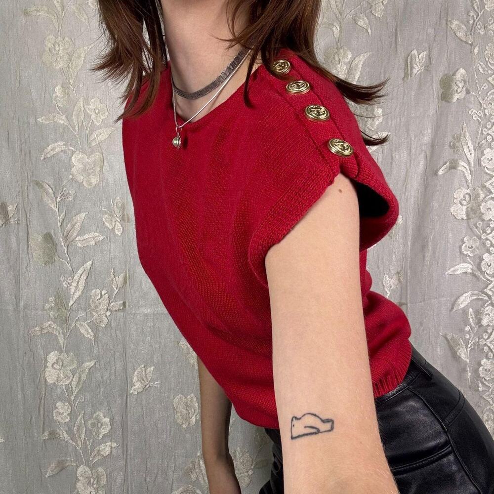 Red short-sleeve knit top accented with stylish gold-tone shoulder buttons